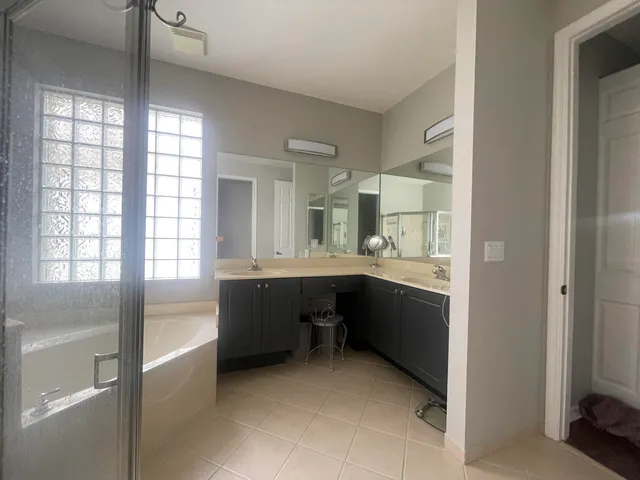 a large bathroom with a large tub and sink