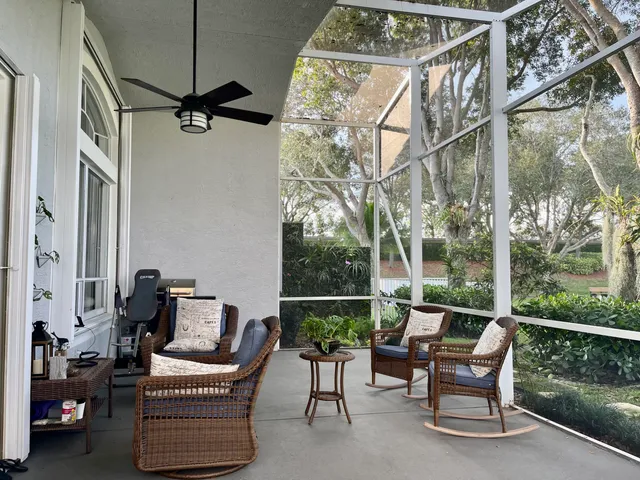 a view of a chair and tables in the balcony