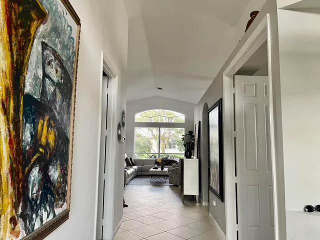 a view of a hallway with living room and furniture