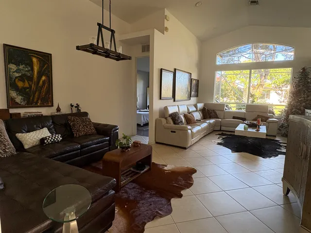 a living room with furniture and a large window