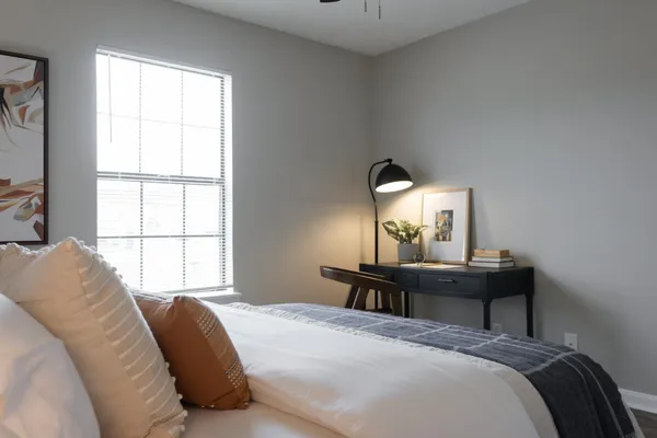 a bedroom with a bed and a window