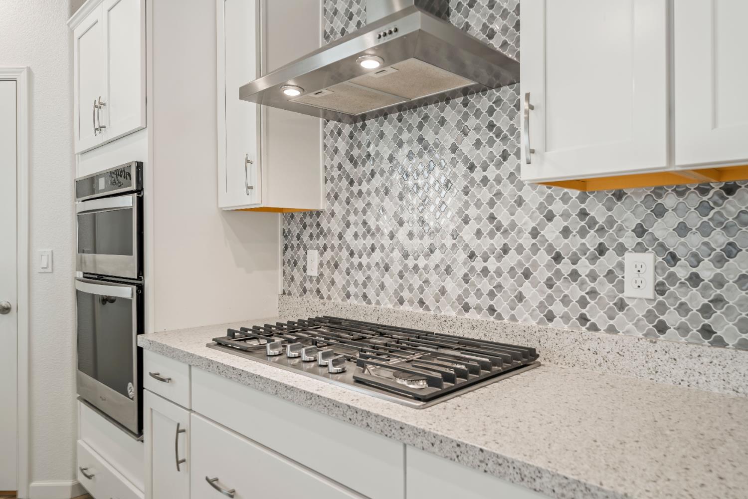 1602 Oleander Avenue Manteca, CA 95337 - Photo 15 of 52 a stove top oven sitting inside of a kitchen