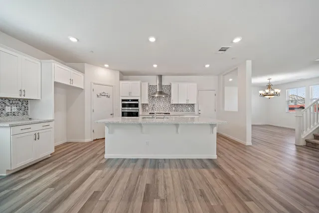 a view of kitchen with wooden floor and electronic appliances
