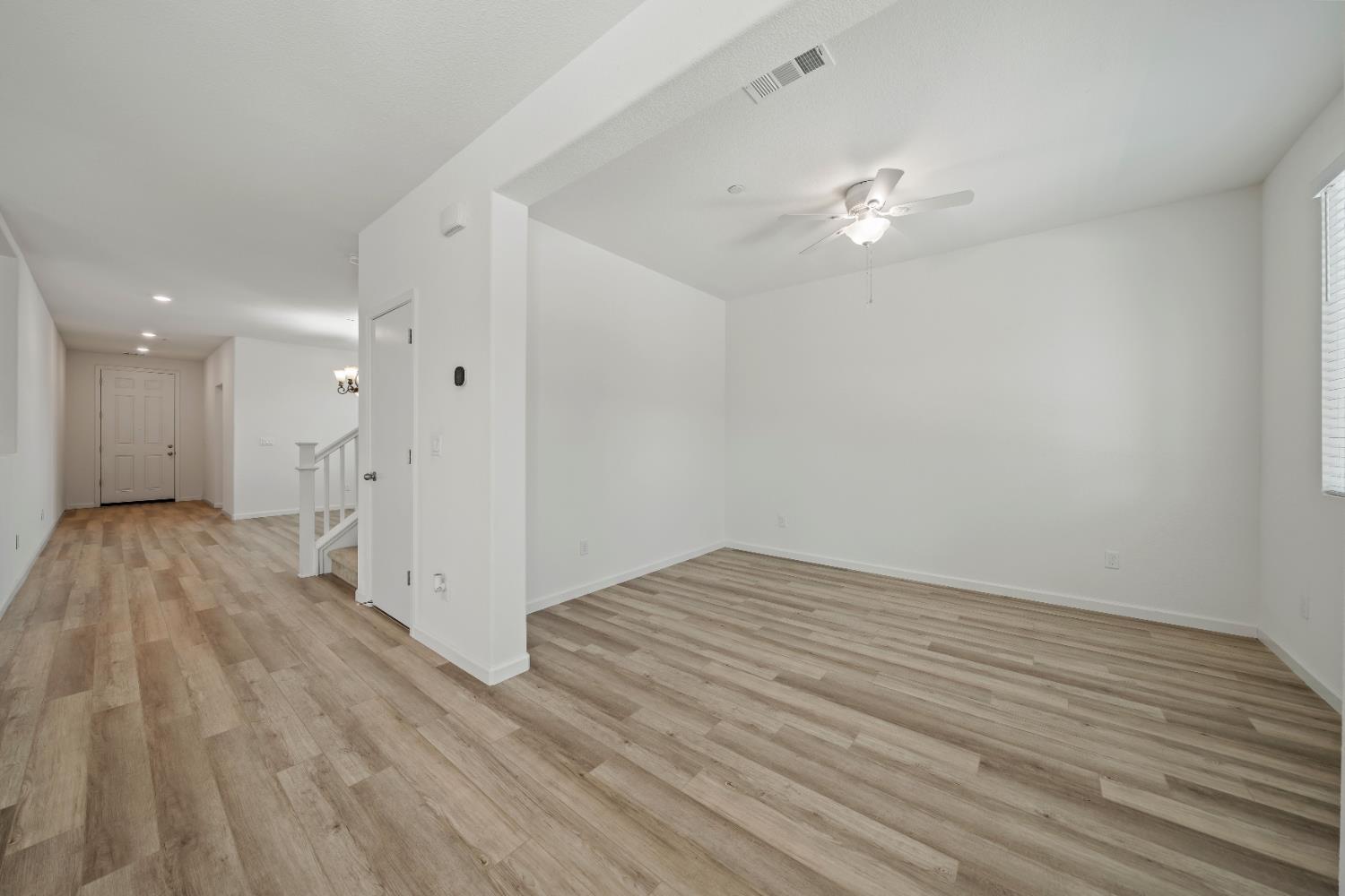 1602 Oleander Avenue Manteca, CA 95337 - Photo 21 of 52 a view of an empty room with wooden floor and a ceiling fan
