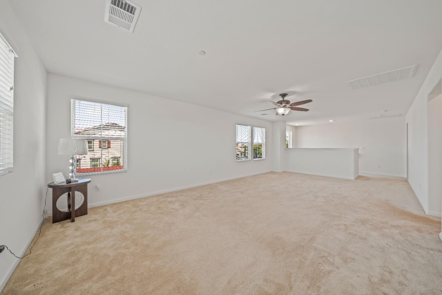 1602 Oleander Avenue Manteca, CA 95337 - Photo 24 of 52 an empty room with windows and ceiling fan view