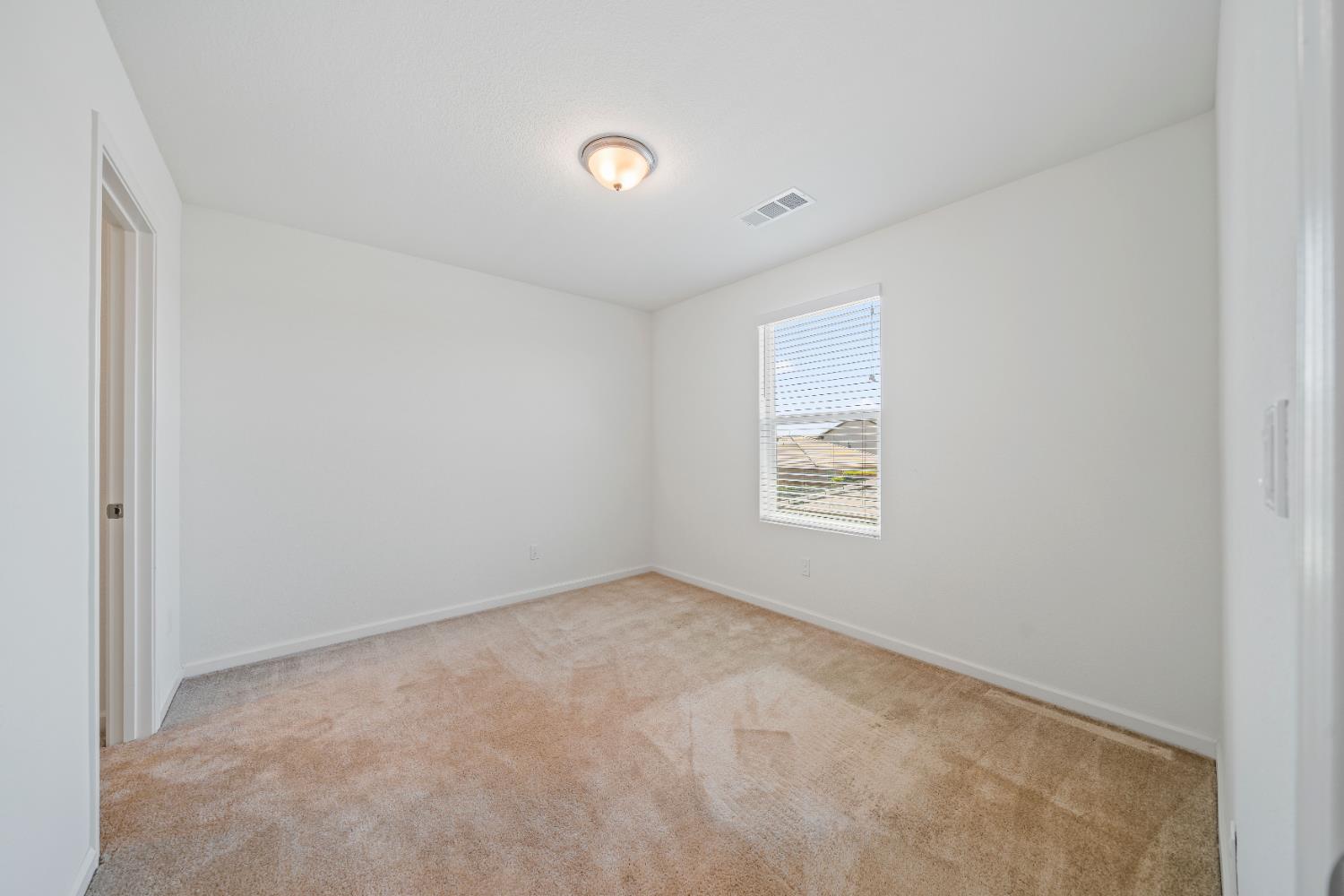 1602 Oleander Avenue Manteca, CA 95337 - Photo 32 of 52 an empty room with a window
