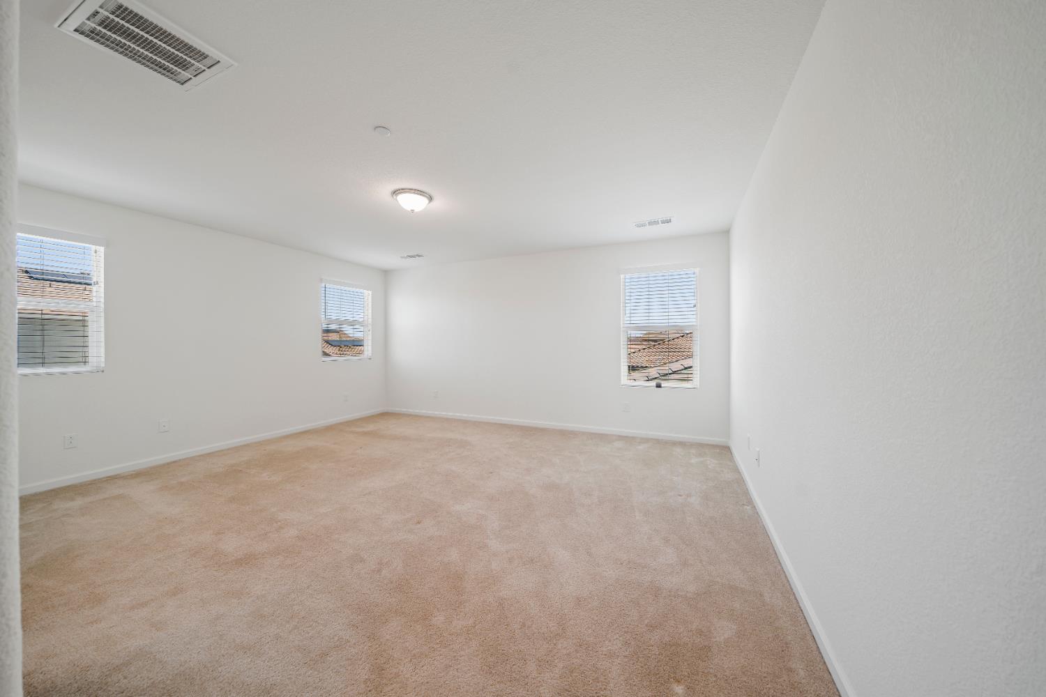 1602 Oleander Avenue Manteca, CA 95337 - Photo 34 of 52 an empty room with windows