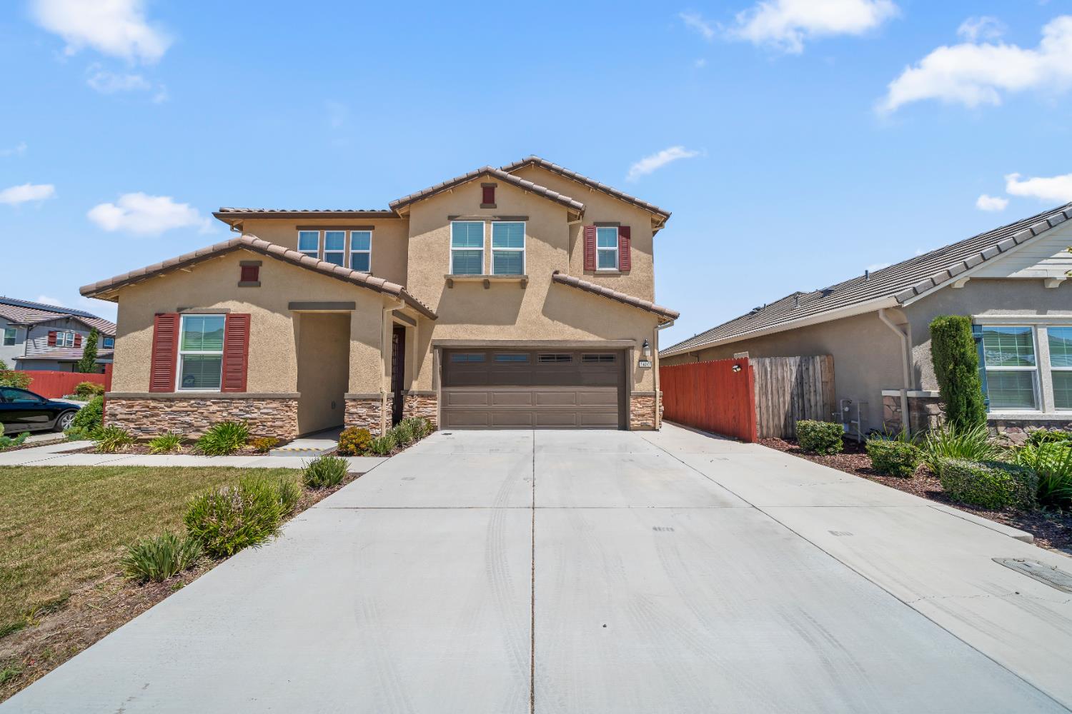 1602 Oleander Avenue Manteca, CA 95337 - Photo 5 of 52 a front view of a house with a yard and garage
