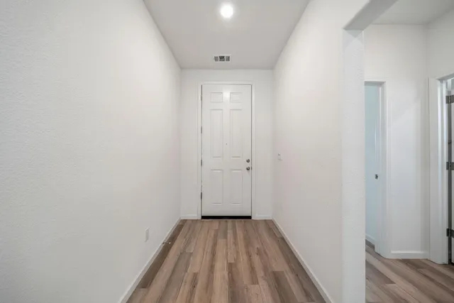 a view of a room with wooden floor