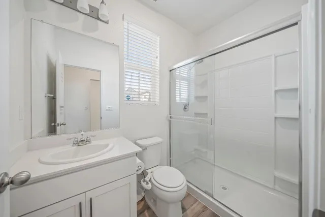 a bathroom with a sink toilet and shower