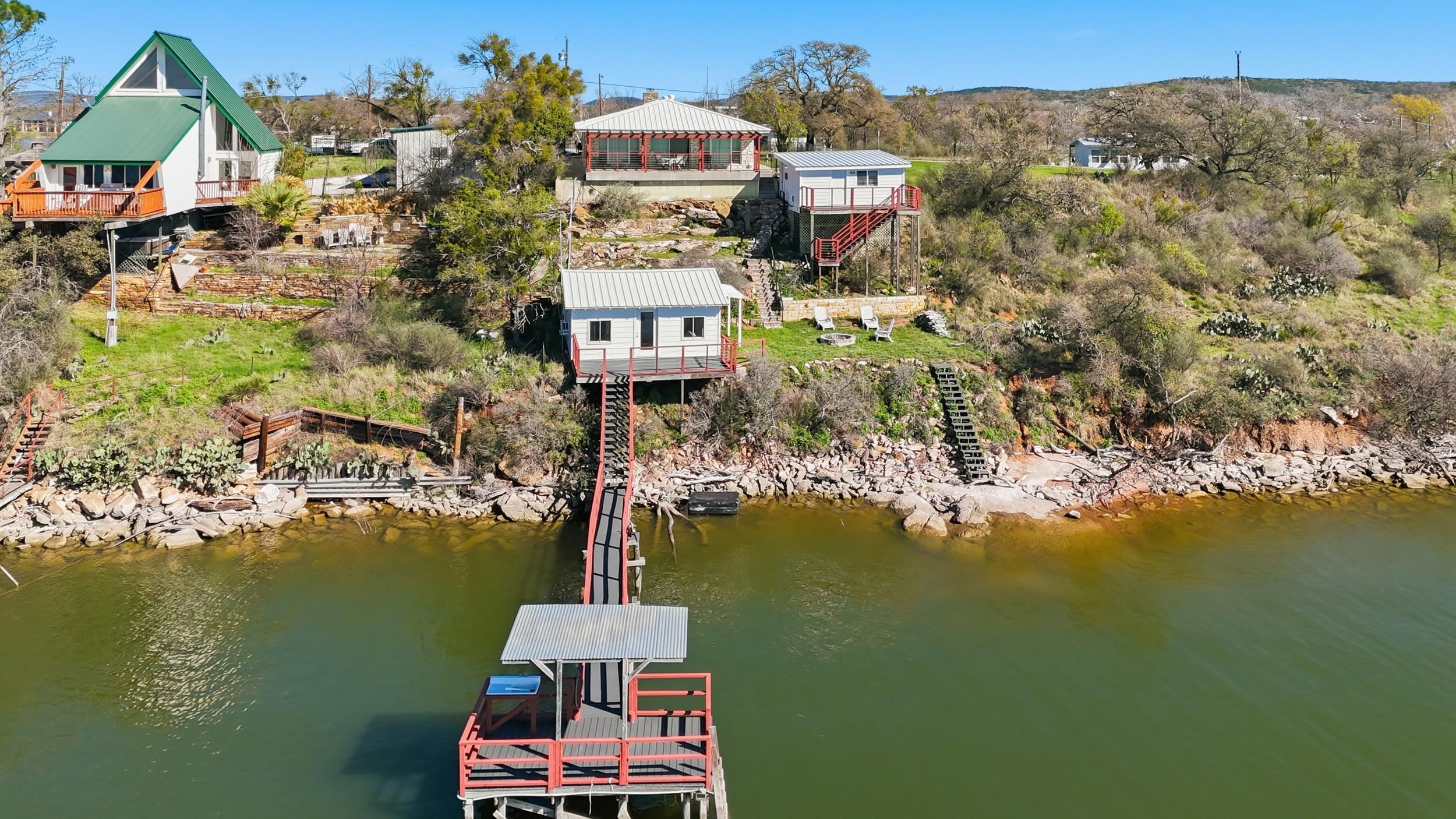919 Lakeshore Loop Tow, TX 78672 - Photo 21 of 33 a aerial view of a house with a garden and lake view