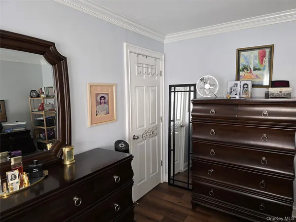 a view of bedroom with workspace and wooden floor
