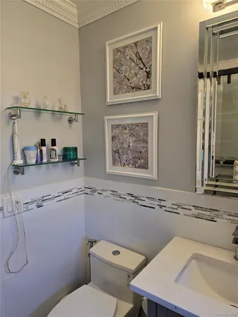 a bathroom with a toilet a sink and a mirror