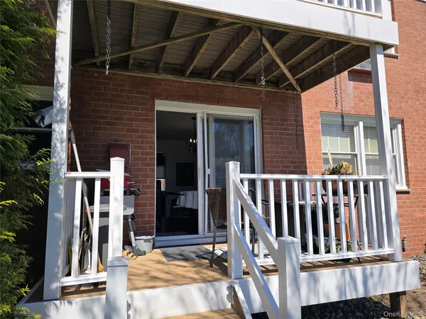 a view of porch with a barbeque grill and floor to ceiling window