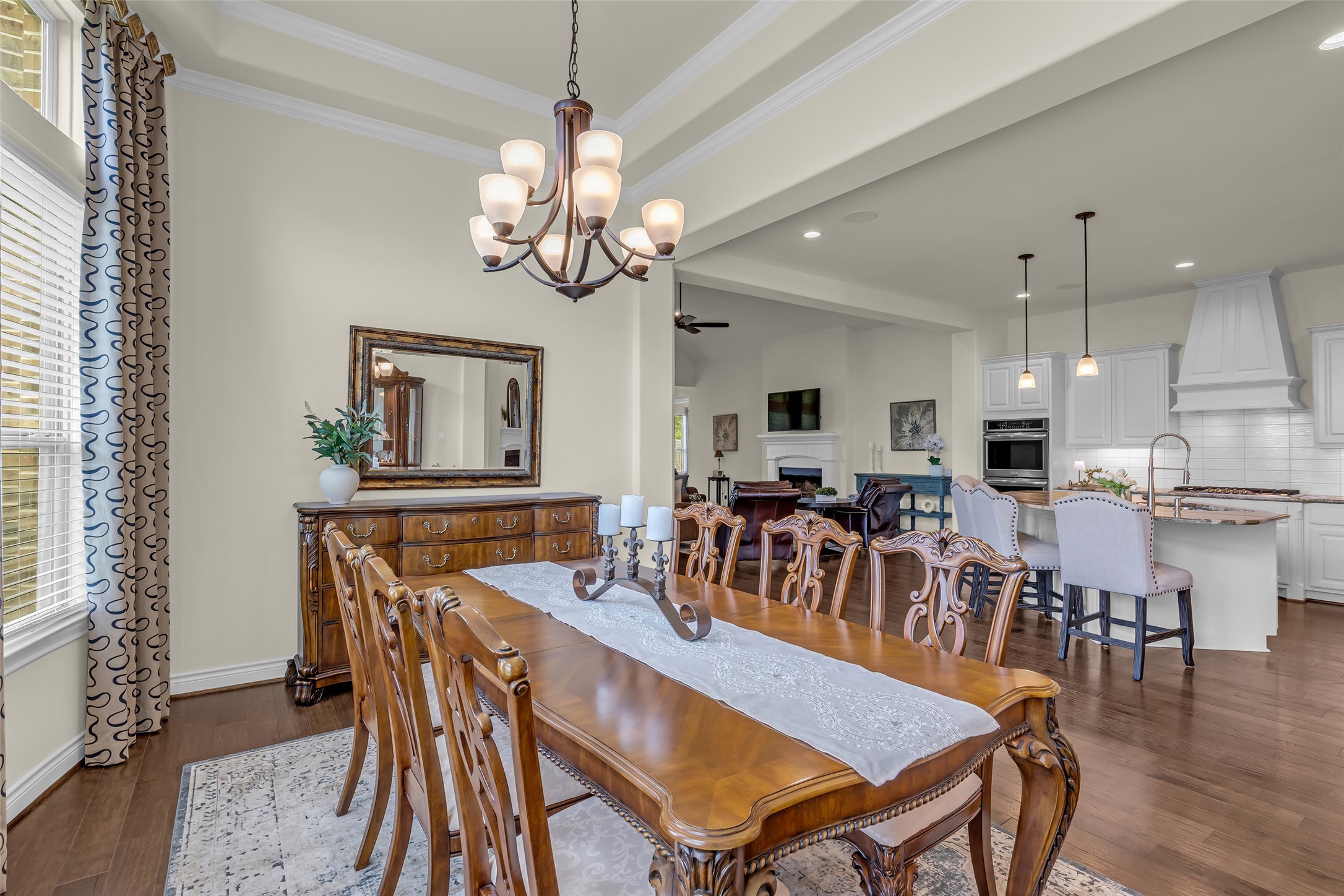 14003 South Evergreen Ridge Court Conroe, TX 77384 - Photo 19 of 43 Formal dining room features a tray ceiling, floor-to-ceiling custom draperies, and convenient access to the kitchen.