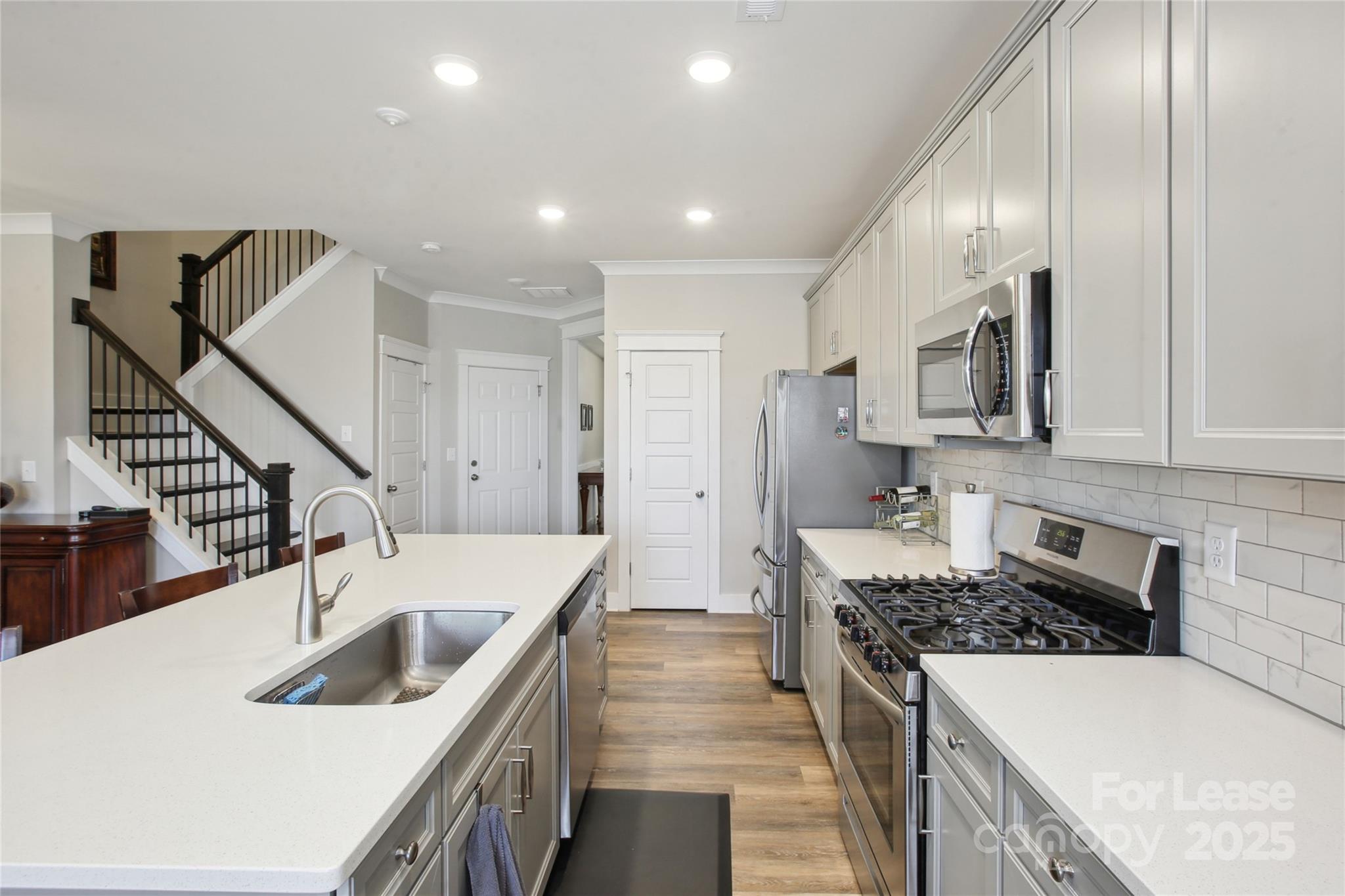 2126 Bexar Trail Matthews, NC 28105 - Photo 5 of 12 a kitchen with stainless steel appliances granite countertop a sink stove and refrigerator
