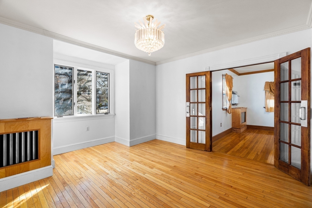 32 Beach Street Malden, MA 02148 - Photo 11 of 31 a view of empty room with wooden floor and fan