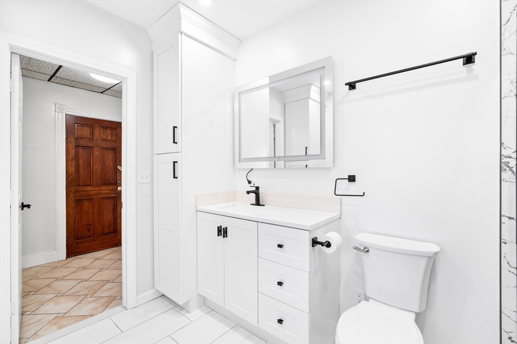 32 Beach Street Malden, MA 02148 - Photo 14 of 31 a bathroom with a sink a toilet and shower