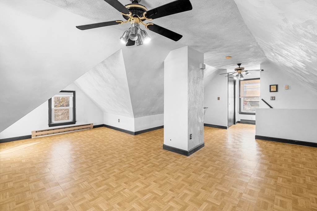 32 Beach Street Malden, MA 02148 - Photo 20 of 31 a view of a livingroom with a stove and a ceiling fan