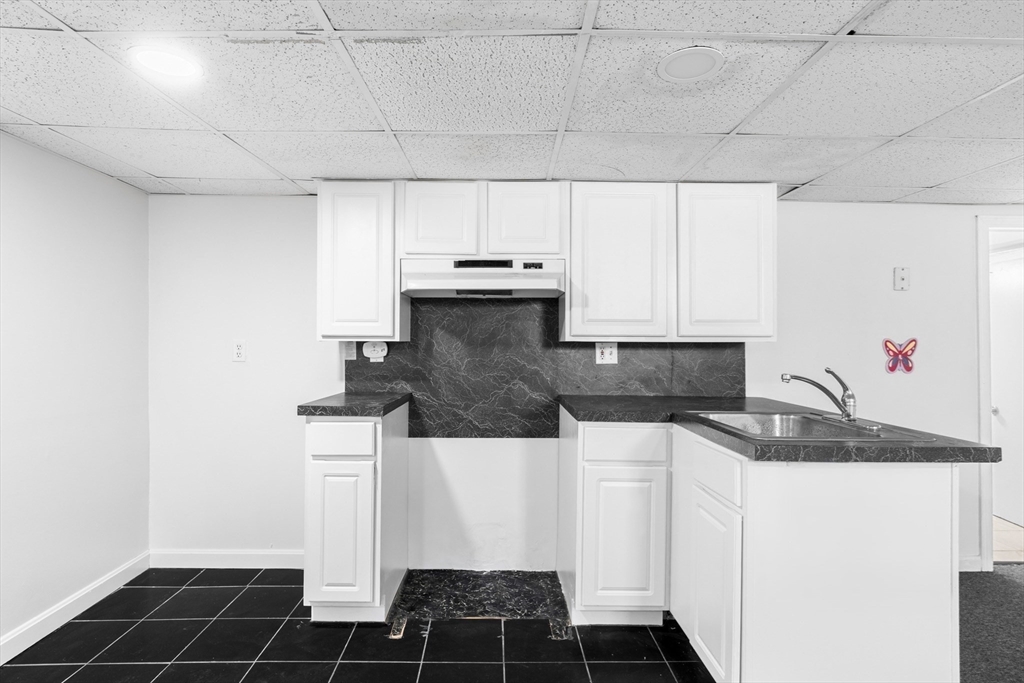32 Beach Street Malden, MA 02148 - Photo 22 of 31 a kitchen with granite countertop a sink and a stove