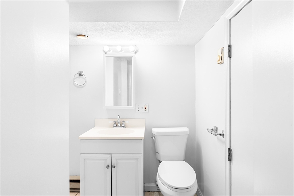 32 Beach Street Malden, MA 02148 - Photo 25 of 31 a bathroom with a sink a toilet and shower