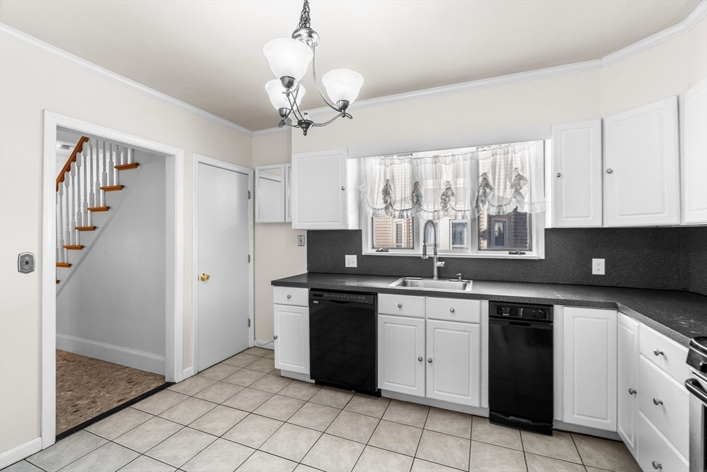 32 Beach Street Malden, MA 02148 - Photo 7 of 31 a kitchen with a sink stove and cabinets