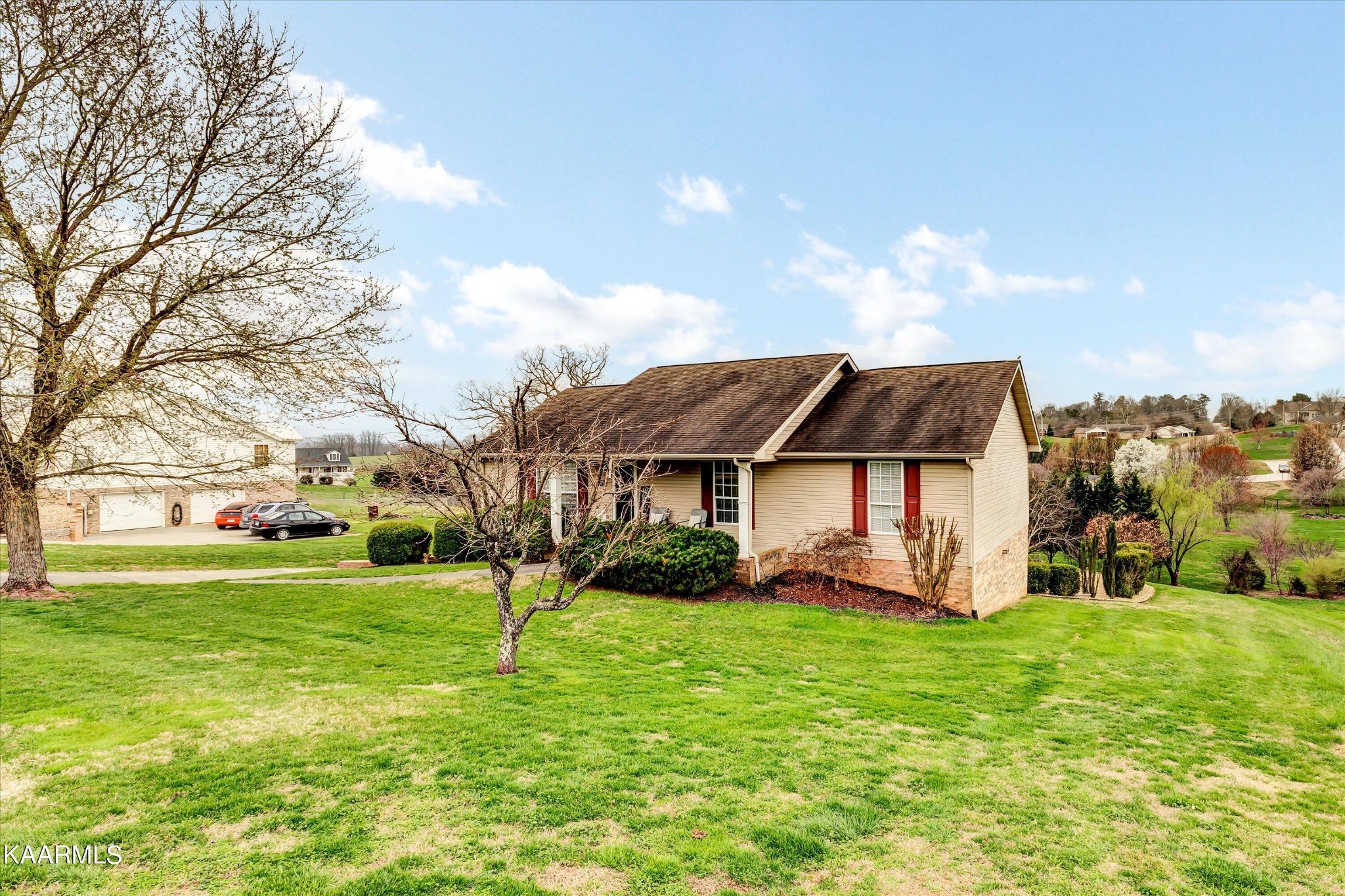 1433 Lambert Road Greenback, TN 37742 - Photo 5 of 34 a view of a house with big yard and large trees