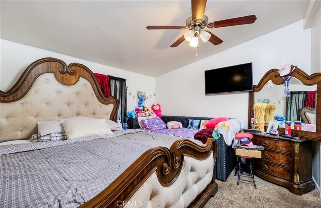 8450 G Avenue Hesperia, CA 92345 - Photo 7 of 10 a bedroom with a bed and a flat screen tv