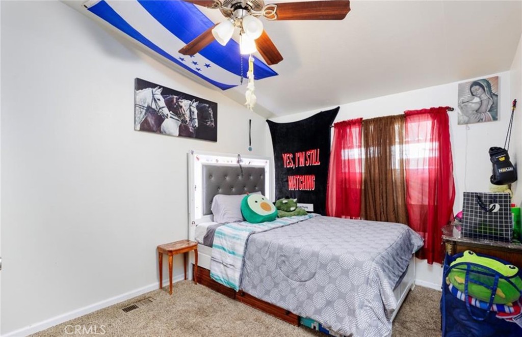 8450 G Avenue Hesperia, CA 92345 - Photo 9 of 10 a bedroom with a bed and a chandelier