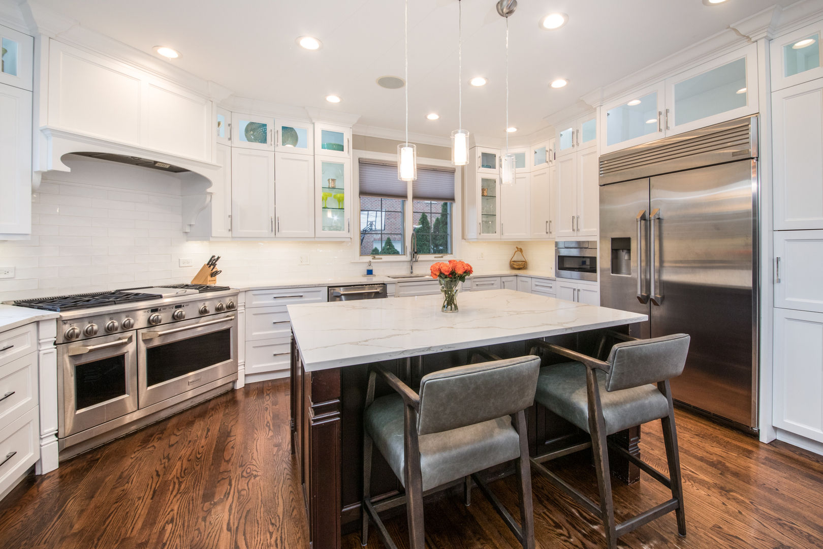 2360 Oak Tree Lane Park Ridge, IL 60068 - Photo 12 of 44 a kitchen with a table chairs stove and microwave
