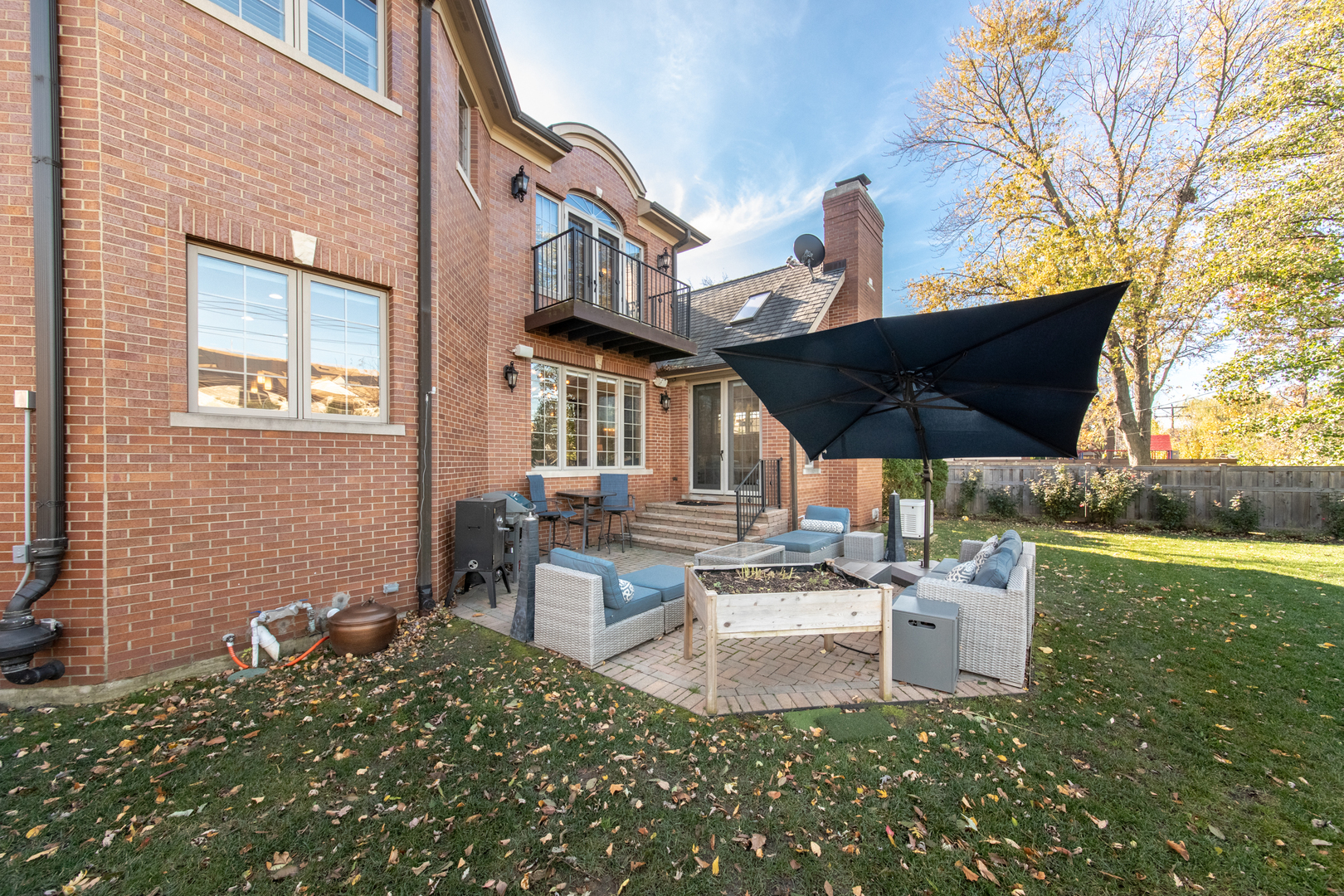 2360 Oak Tree Lane Park Ridge, IL 60068 - Photo 39 of 44 a view of a patio with table and chairs potted plants and a large tree