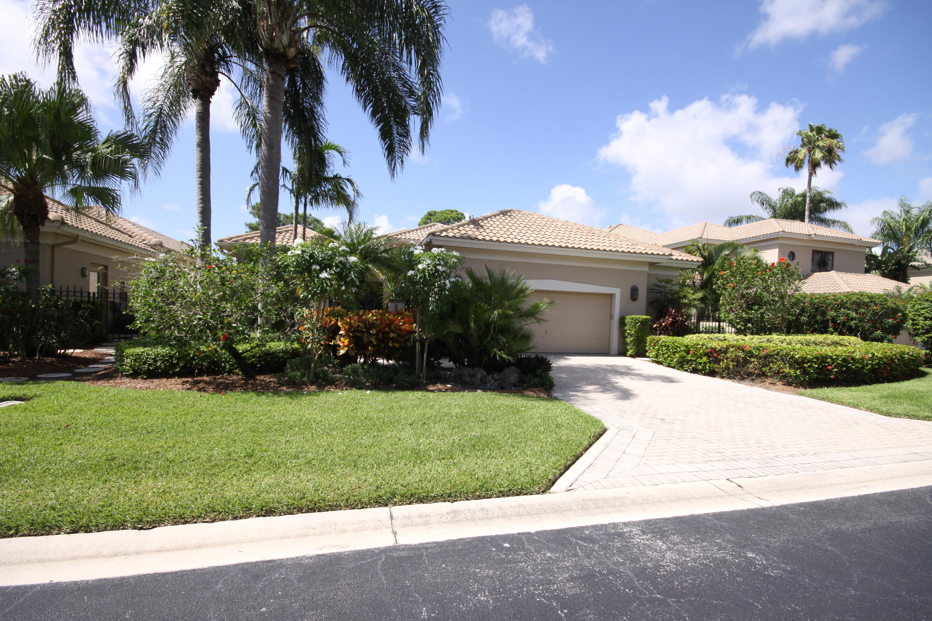2264 Northwest 60th Street Boca Raton, FL 33496 - Photo 19 of 19 front view of house with a yard and palm trees