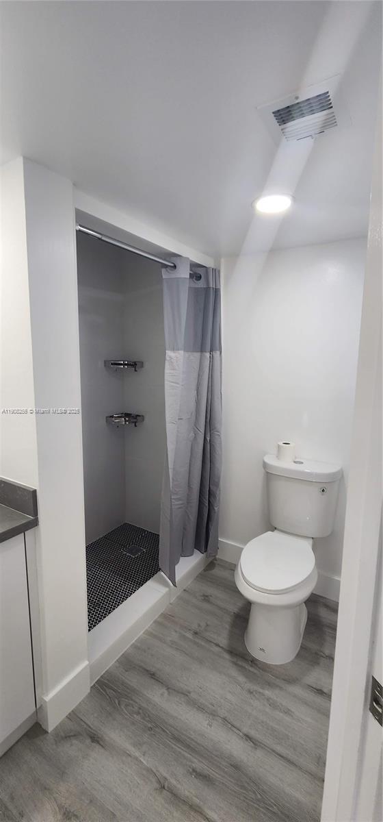 8040 North Colony Circle, Unit 309 Tamarac, FL 33321 - Photo 13 of 15 a bathroom with a toilet and a shower