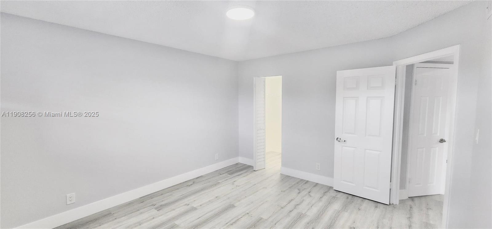 8040 North Colony Circle, Unit 309 Tamarac, FL 33321 - Photo 9 of 15 a view of an empty room with wooden floor