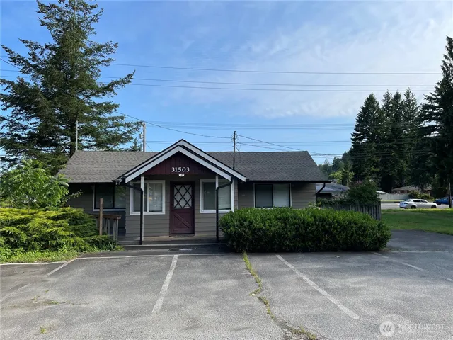 a front view of a house with a garden