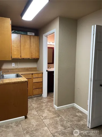 a view of kitchen with cabinets