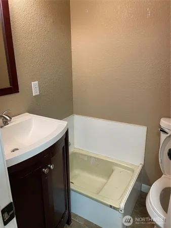 a bathroom with a sink a toilet and bathtub