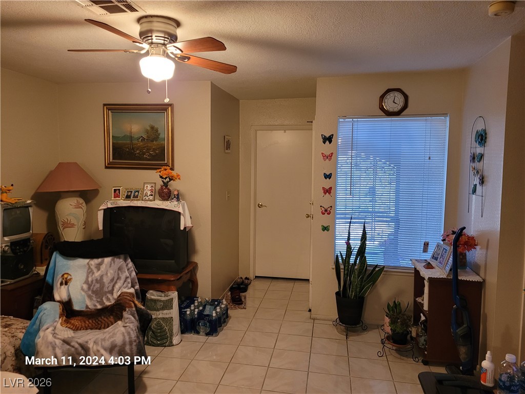 809 Hedge Way, Unit 3 Las Vegas, NV 89110 - Photo 6 of 10 Foyer with light tile patterned flooring, ceiling fan, and a textured ceiling