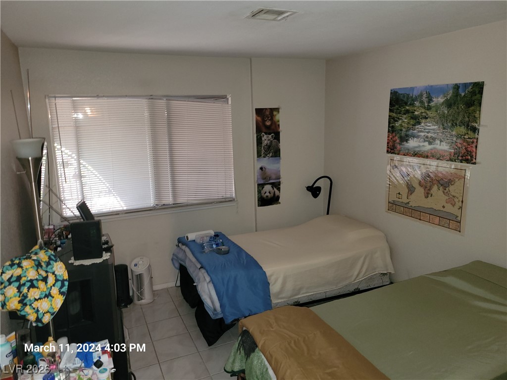 809 Hedge Way, Unit 3 Las Vegas, NV 89110 - Photo 8 of 10 Bedroom with light tile patterned floors