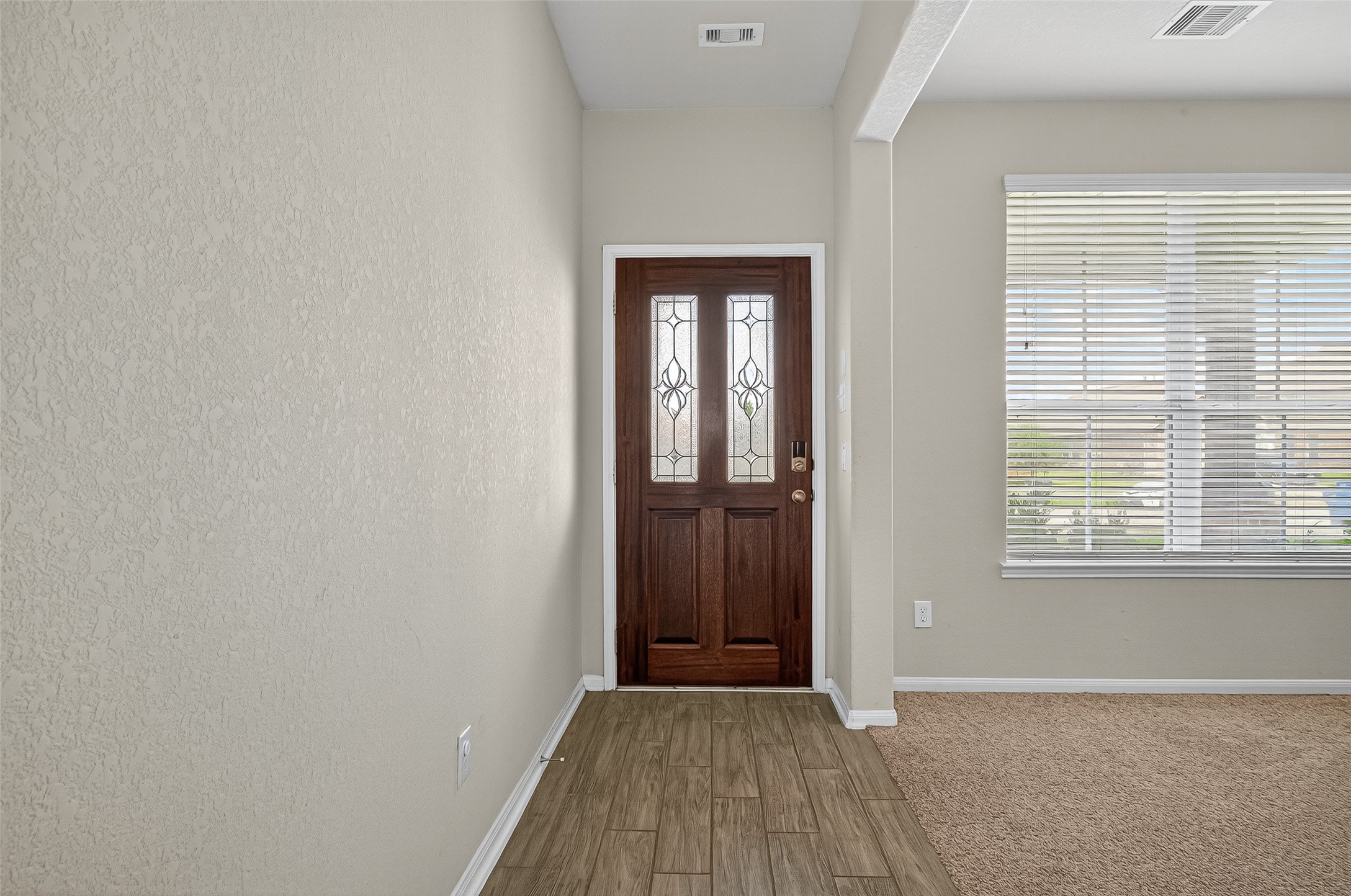 3035 Tandem Court Rosenberg, TX 77471 - Photo 4 of 28 a view of an empty room with wooden floor and a window