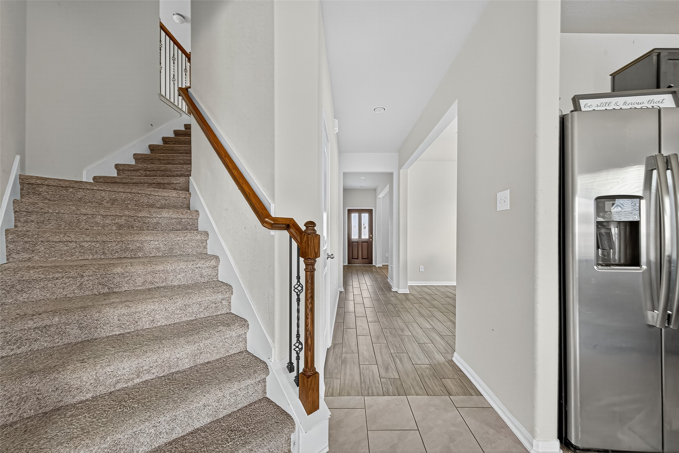 3035 Tandem Court Rosenberg, TX 77471 - Photo 10 of 28 a view of a hallway with staircase and white kitchen