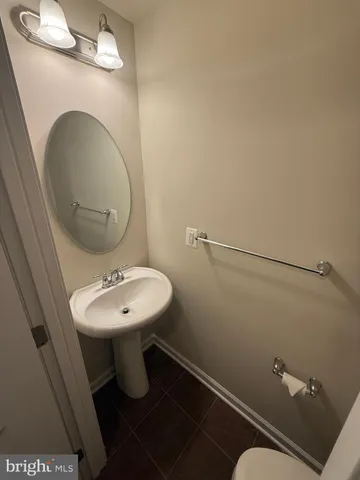 a bathroom with a sink mirror and toilet