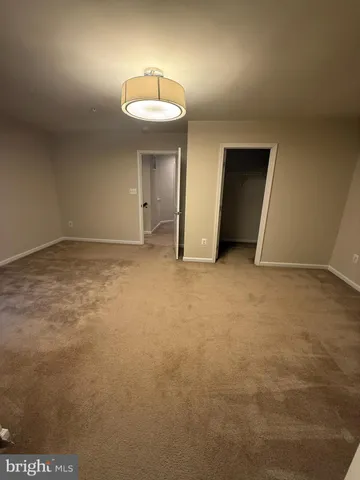 an empty room with a empty space and chandelier