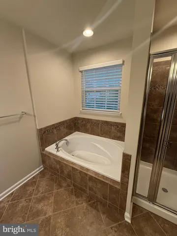 a bath tub sitting in a bathroom next to a sink