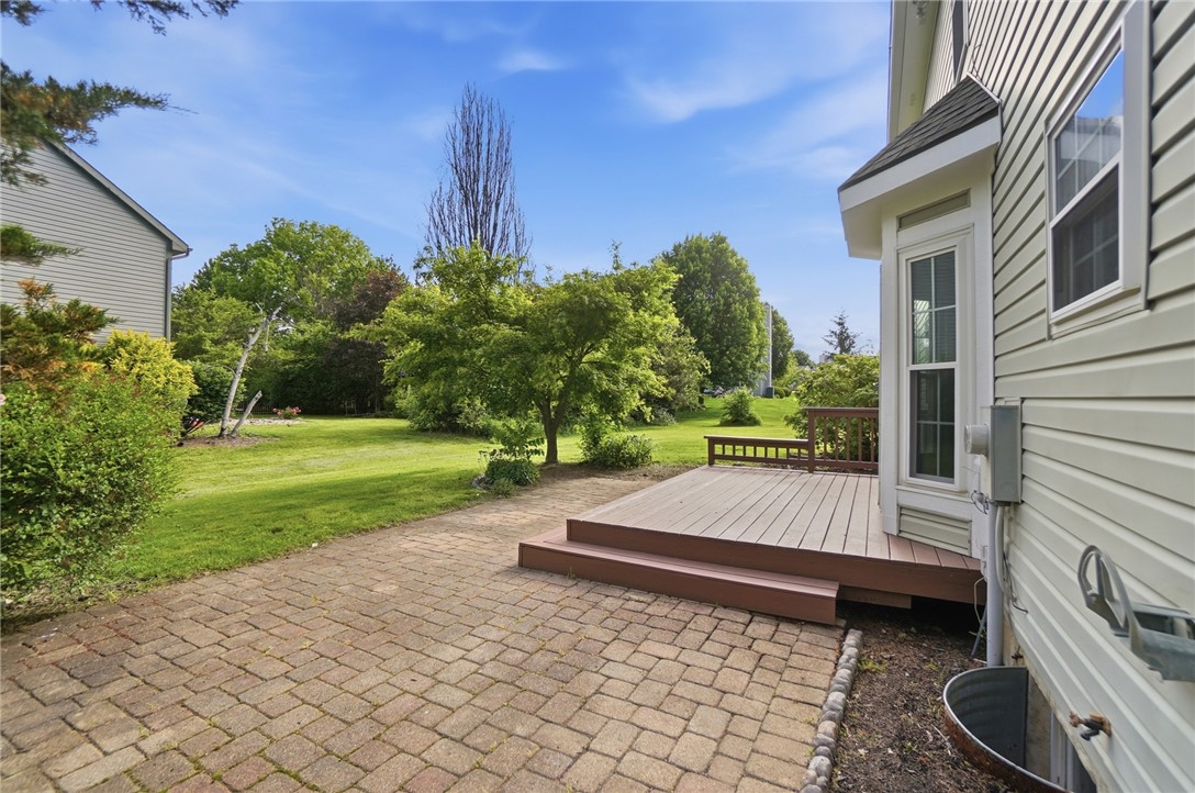 10 Chase Court Springboro, OH 45066 - Photo 66 of 75 This inviting outdoor space features a spacious deck and paver patio, perfect for enjoying the expansive yard.