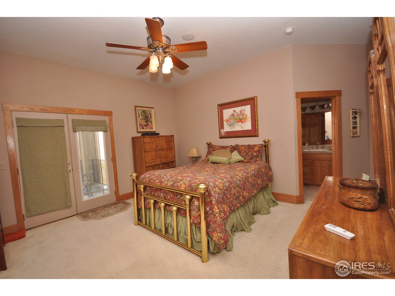 7717 Poudre River Road Greeley, CO 80634 - Photo 14 of 25 master bedroom/doors to deck
