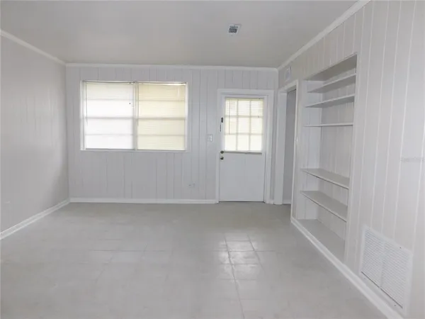 a view of an empty room with a window