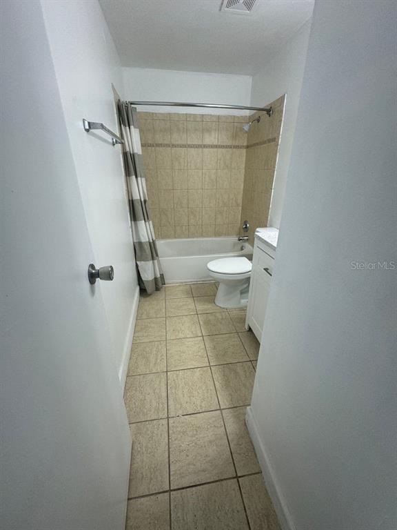 717 Southwest 75th Street, Unit 101 Gainesville, FL 32607 - Photo 13 of 19 a bathroom with a toilet and a shower