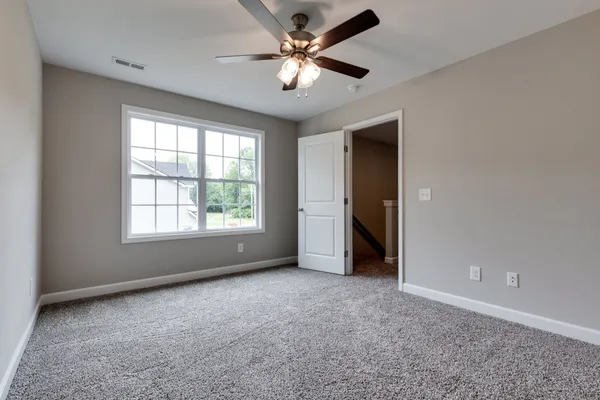a view of a livingroom with a ceiling fan and window