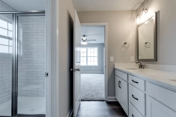 a bathroom with a double vanity sink and mirror